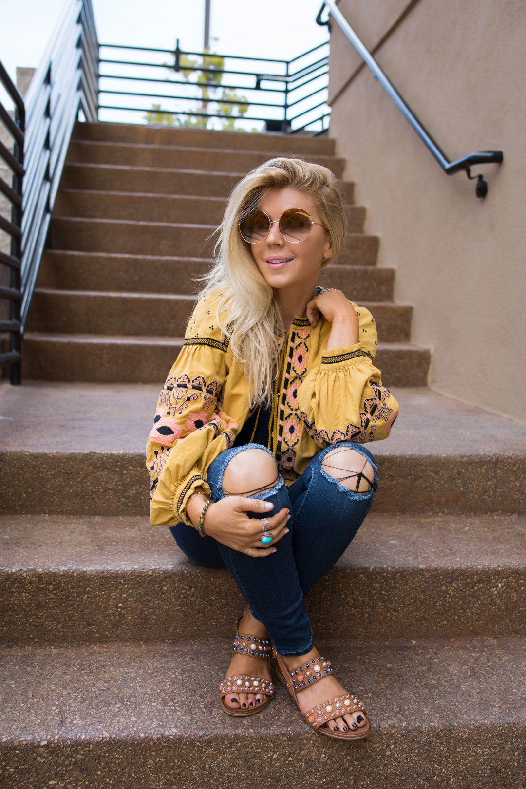 lisa allen of lunchpails and lipstick wearing a yellow free people swing jacket and paige jeans with a cotton citizen tee and studded sandals.