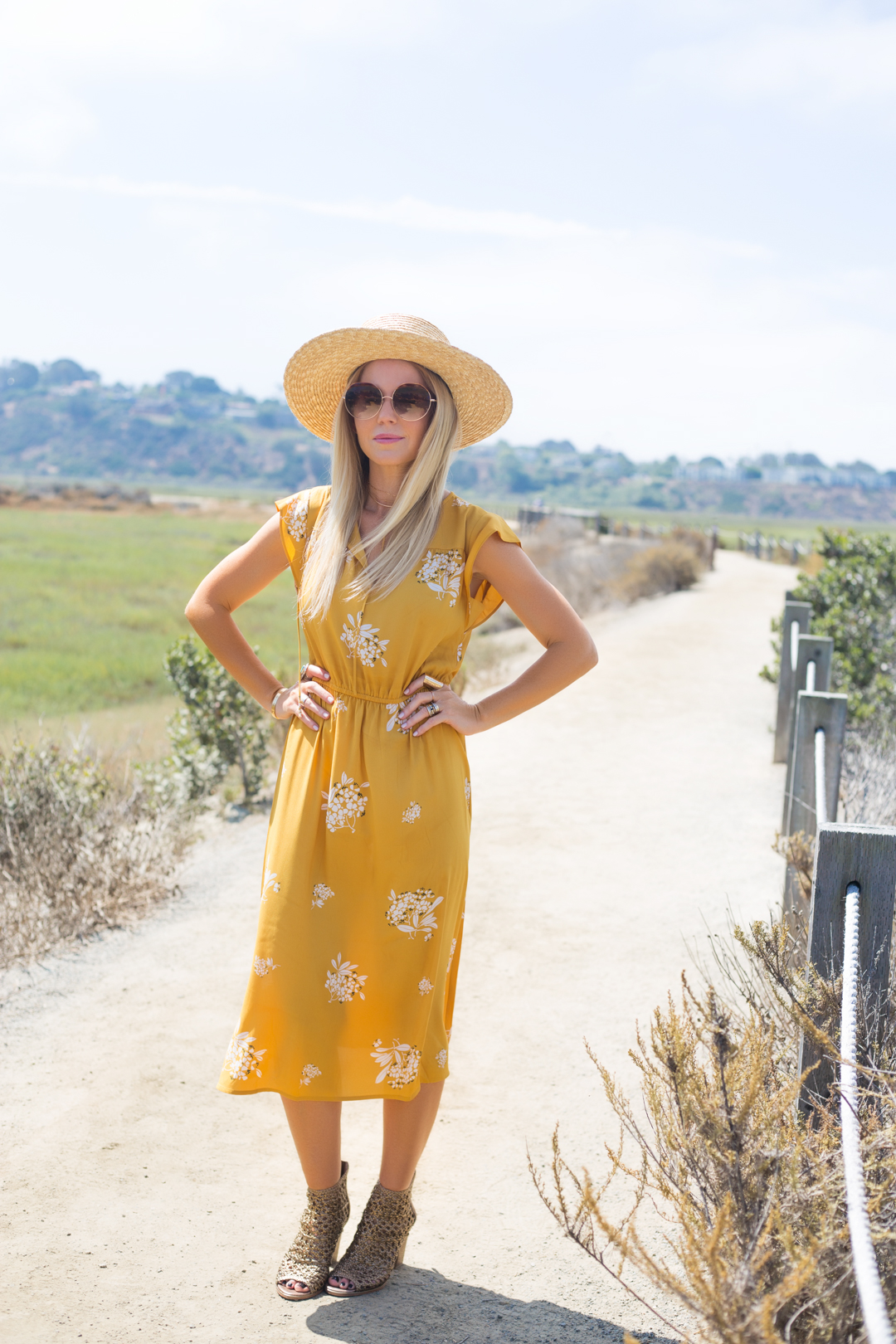 lisa allen of lunchpails and lipstick wearing a yellow floral dress and donald liner booties