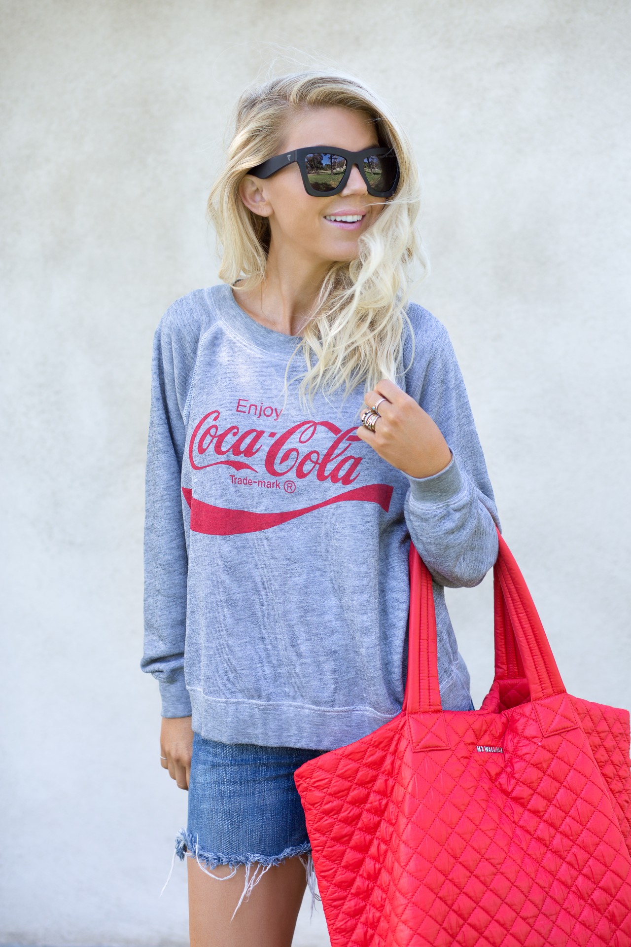 lisa allen of lunchpails and lipstick wearing a Coca-Cola Wildfox sweater and cut-offs with a MZ wallace tote