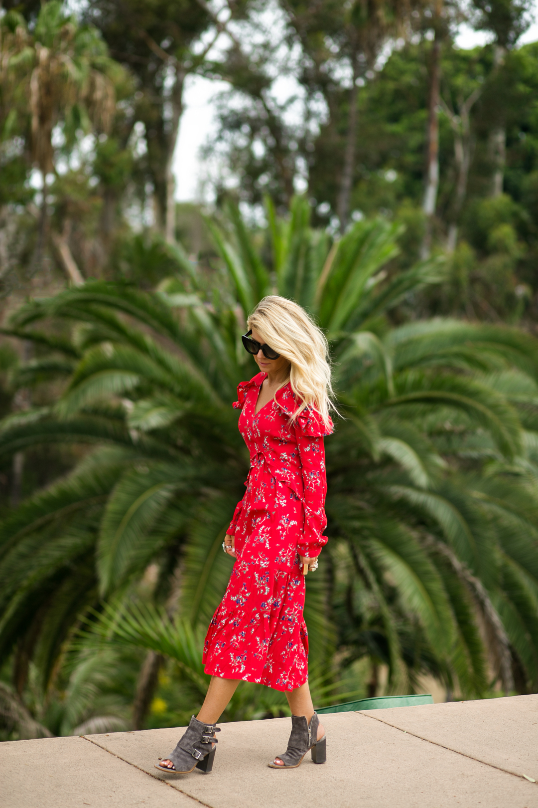 Lisa Allen of Lunchpails and Lipstick wearing a red floral dress from ASOS with Rag and Bone sandals and Valley eyewear 