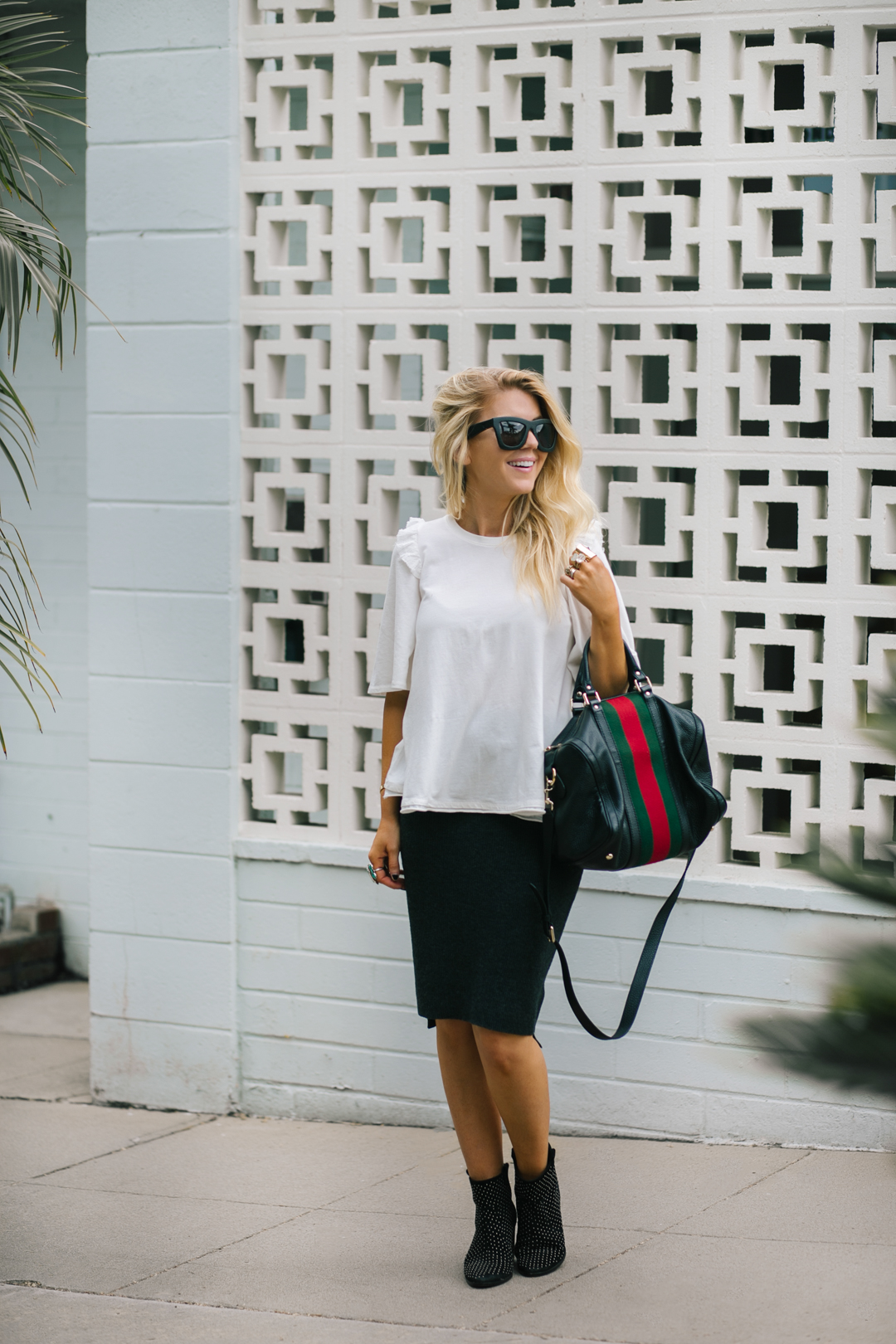 Lisa Allen of LunchPails and Lipstick wearing a ruffle anther tee with a Madewell ribbed skirt, Rebecca Minkoff Studded booties and a Gucci Boston bag