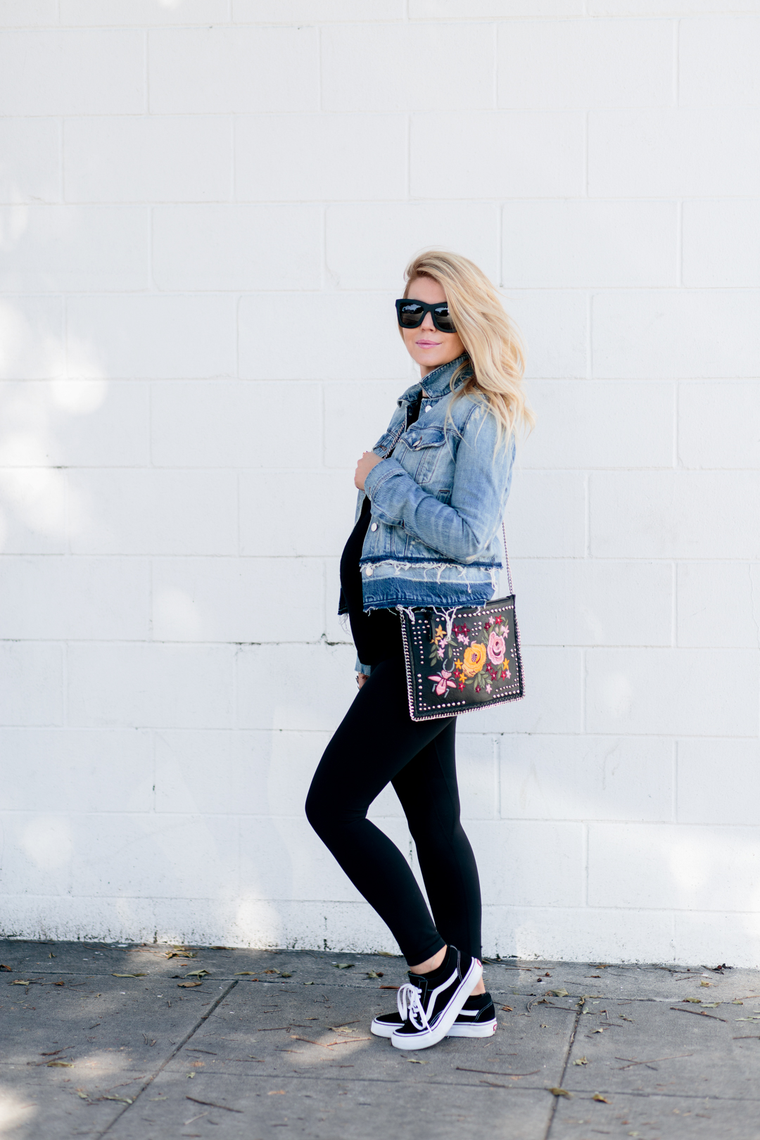 Lisa Allen of LunchPails and Lipstick wearing a J Brand denim jacket with black leggings, a topshop embroidered bag and vans