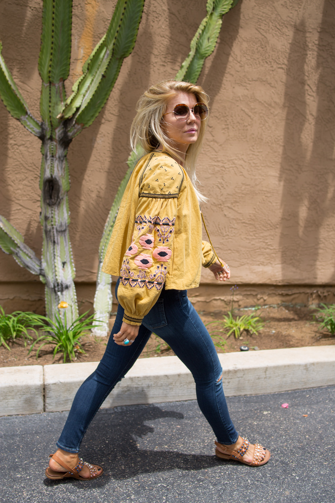 lisa allen of lunchpails and lipstick wearing a yellow free people swing jacket and paige jeans with a cotton citizen tee and studded sandals 