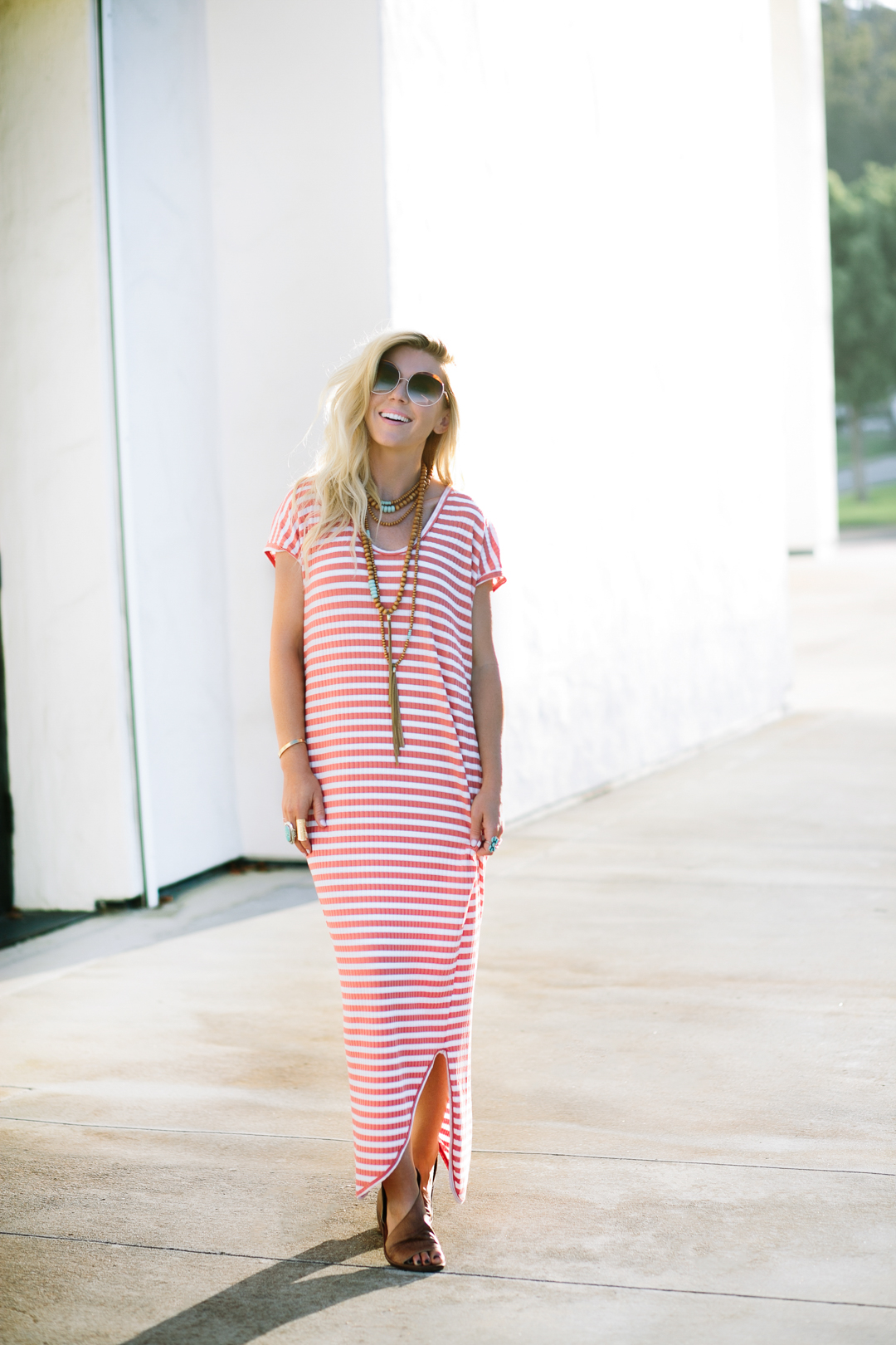 lisa allen of lunchpails and lipstick wearing a stripe maxi dress from free people and free people sandals with cleobella sunglasses 