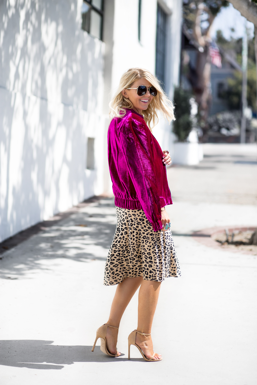 Lisa Allen of LunchPails and Lipstick wearing a plum velvet bomber jacket with a kate moss leopard slip dress. all from Neiman Marcus. 