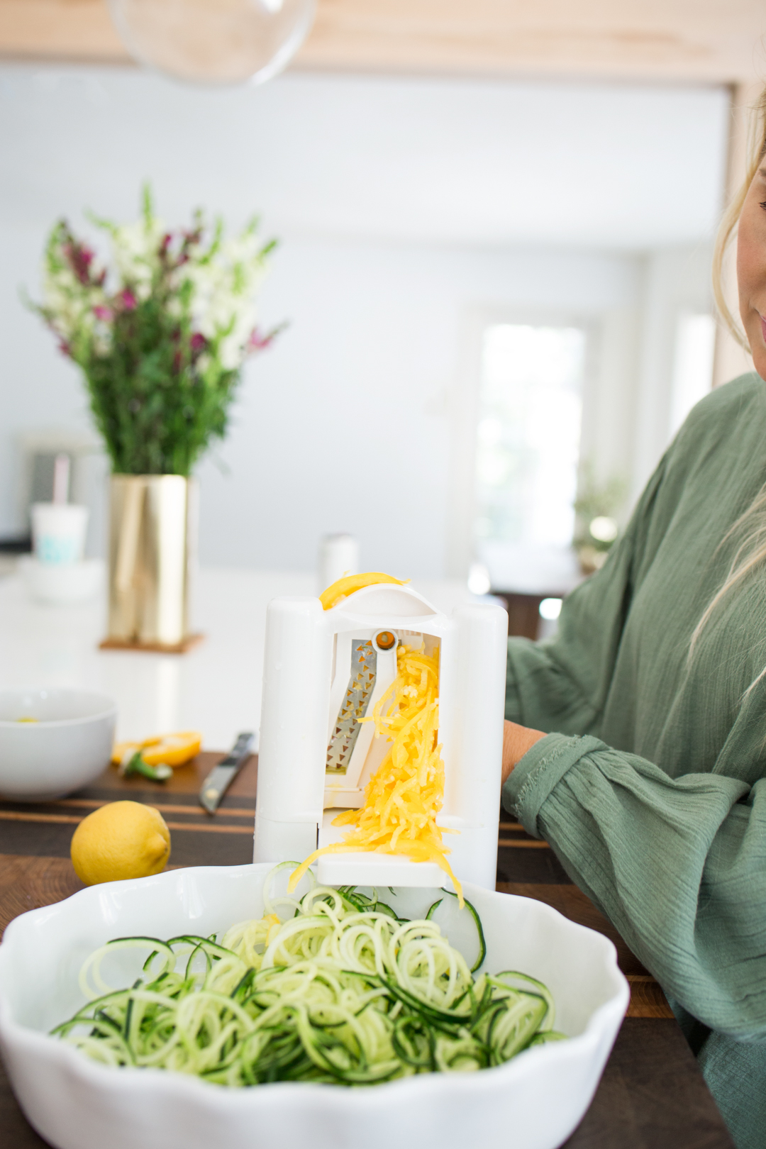 Lisa Allen of LunchPails and Lipstick making a Greek salad using a spiralizer and ingredients from Trader Joe's 