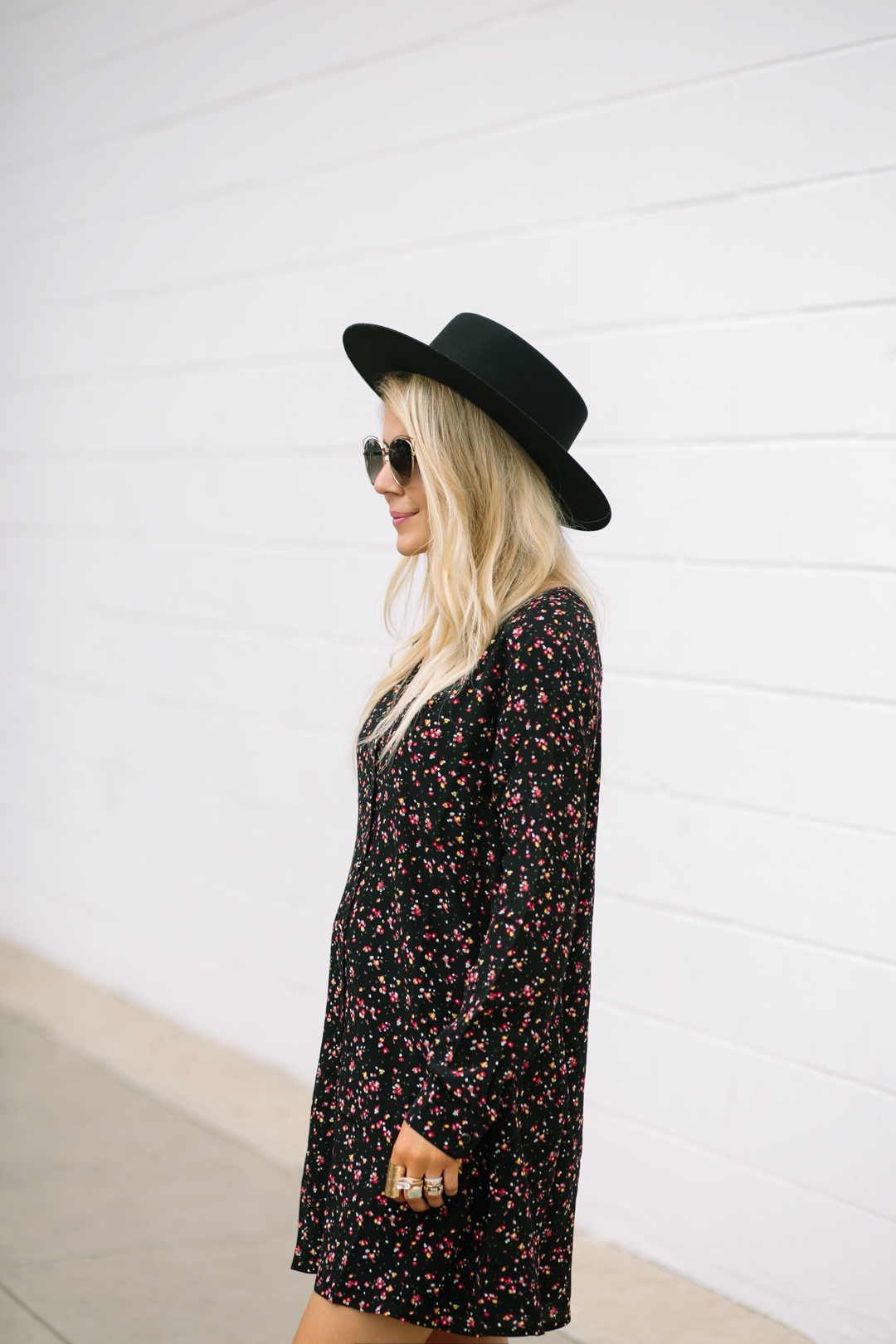 Lisa Allen of LunchPails and Lipstick wearing a black boater hat with a floral mini dress from Madewell and Chanel loafers