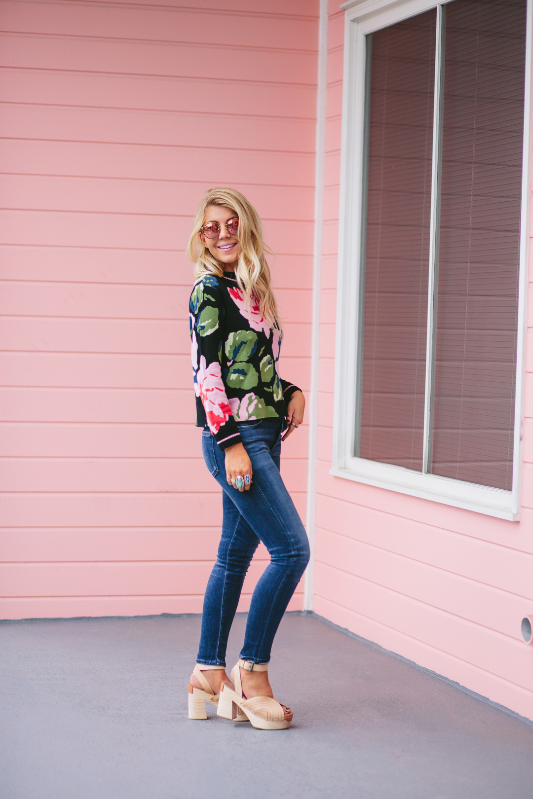 Lisa Allen of Lucnhpails and Lipstick wearing a floral Anthro sweater, jeans and free people clogs