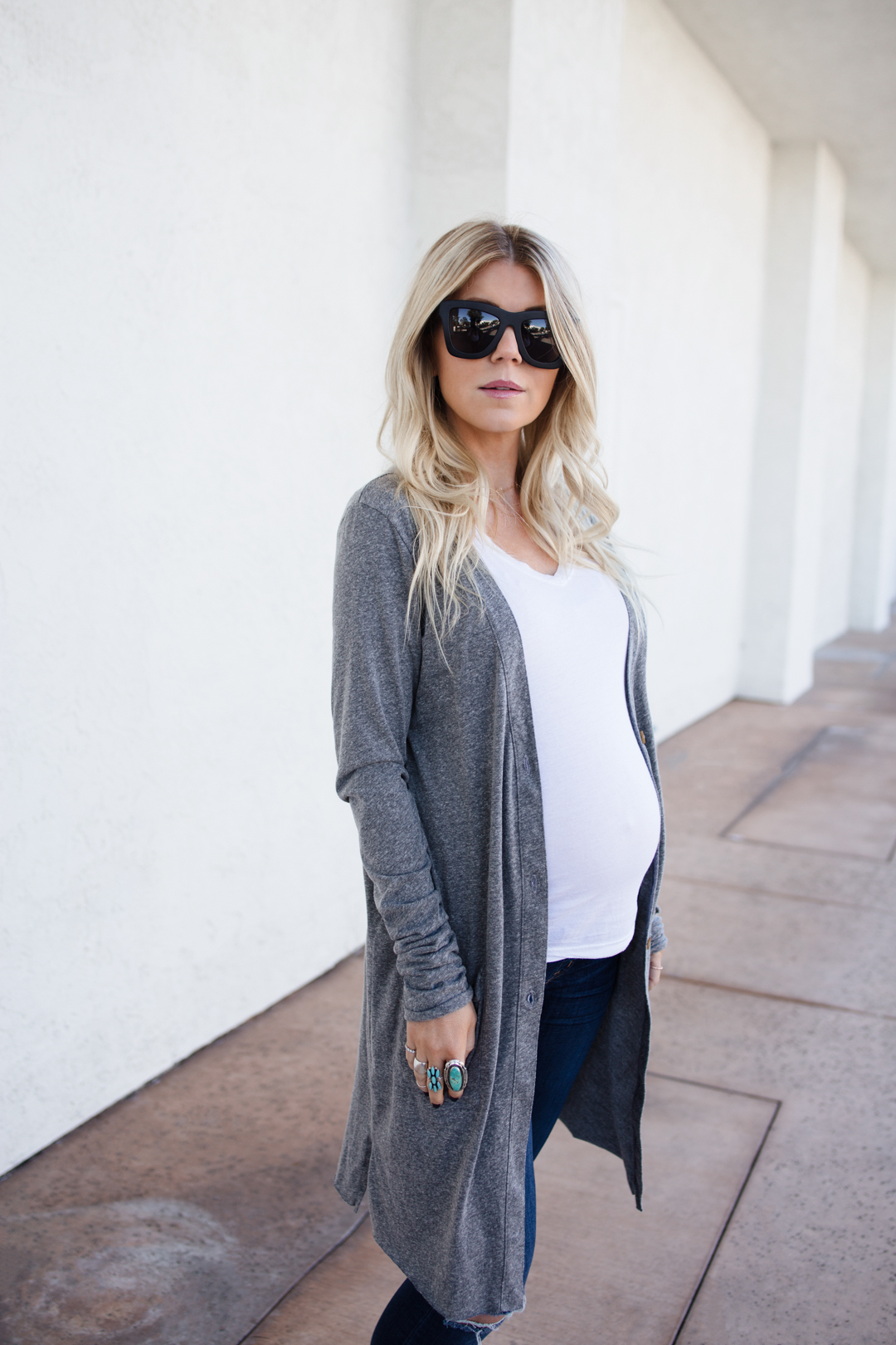 Lisa Allen wearing a grey anthropologie cardigan, madewell maternity jeans and checkered Vans